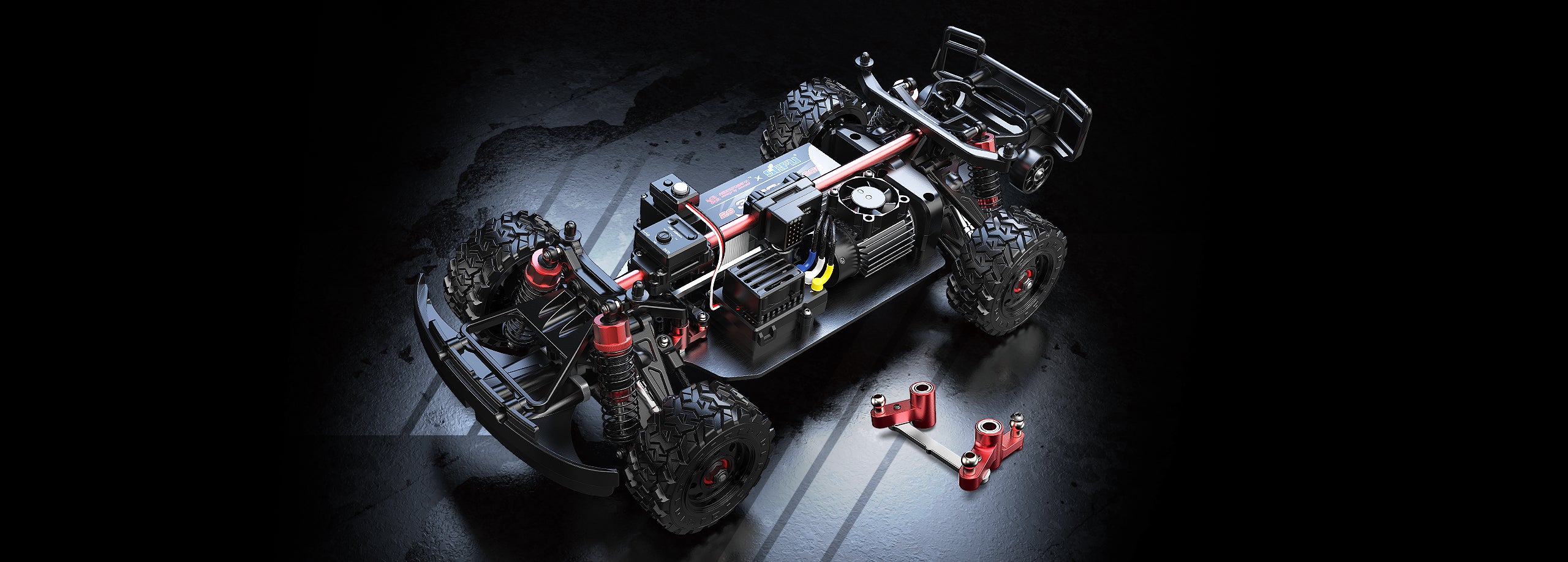 Close-up of a remote control car chassis with components on a dark background