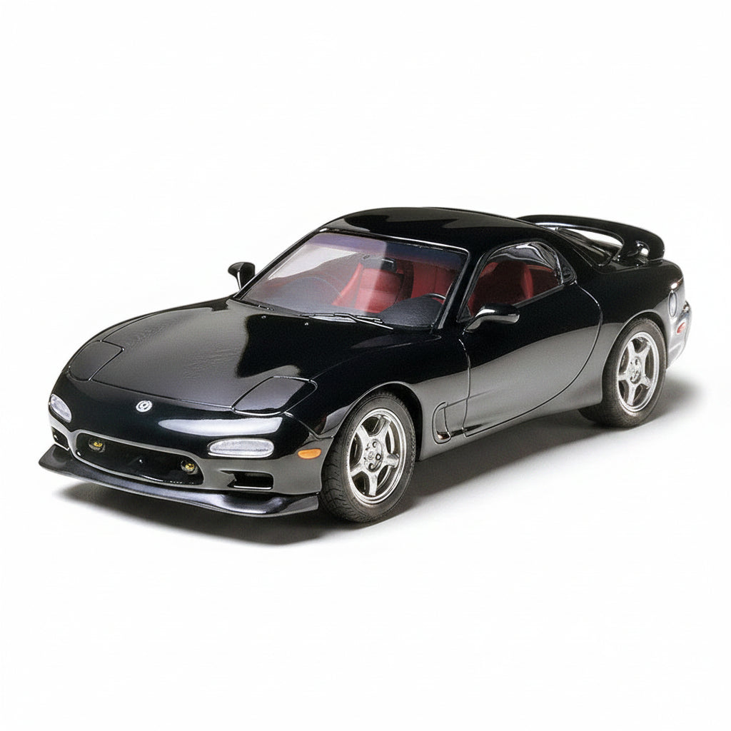 Black TAMIYA 1/24 MAZDA RX-7 model kit on a white background