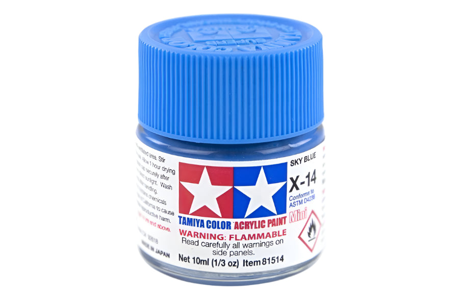 A small bottle of Tamiya acrylic mini paint in sky blue color, labeled X-14.