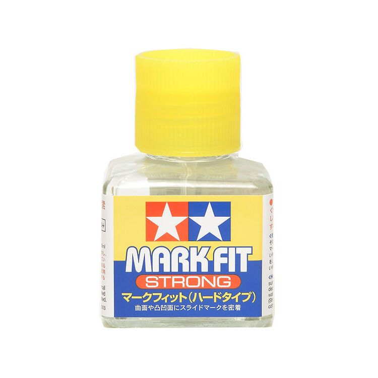 Bottle of Tamiya Mark Fit Strong paint with yellow cap on a white background