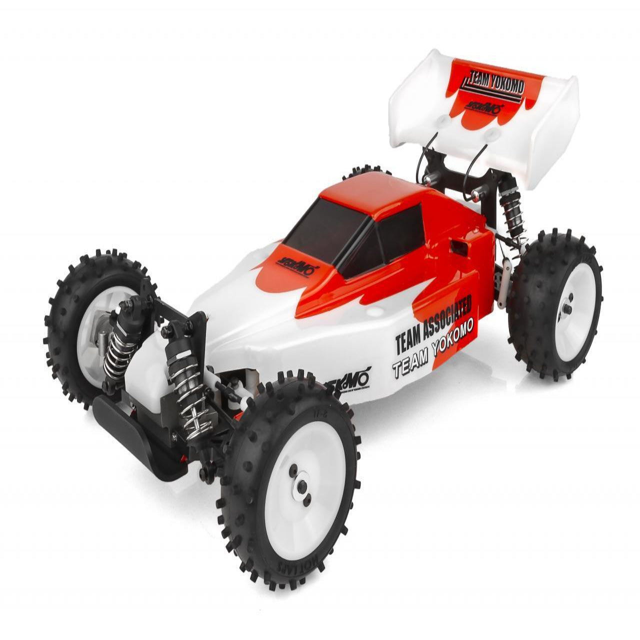 A red and white Yokomo YZ-10 Classic Kit remote control car with black Off-road tires, shown from a side angle with the chassis visible.