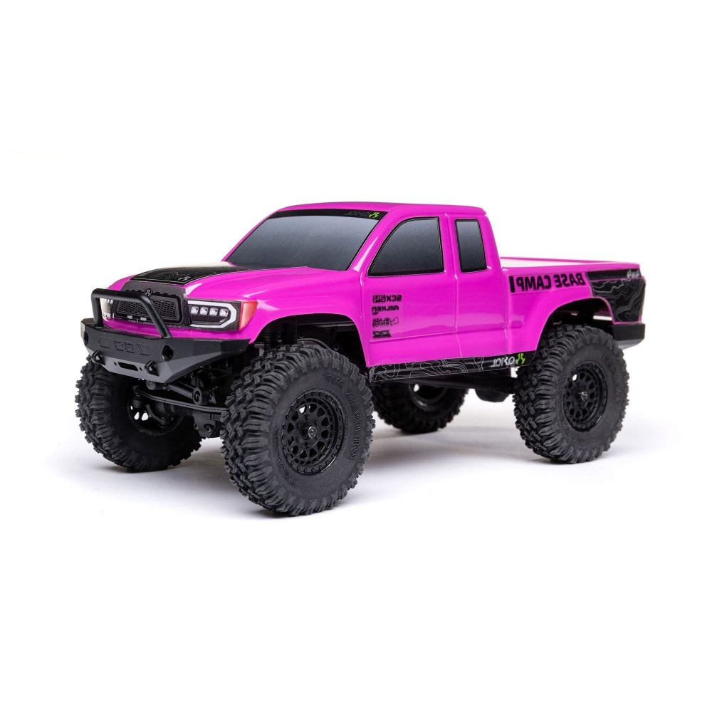 Pink toy truck with large wheels on a white background