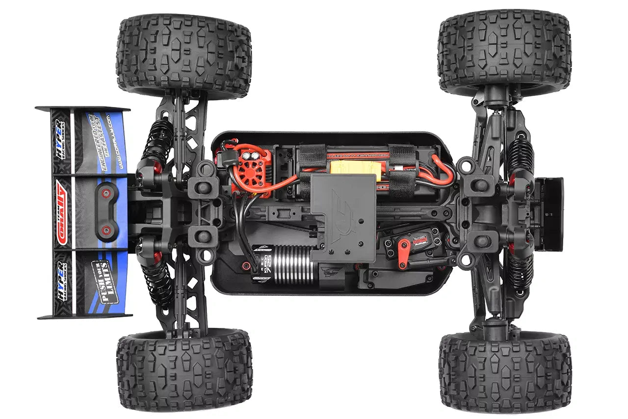 Close-up of a Team Corally Punisher4 remote control car chassis with visible components on a white background
