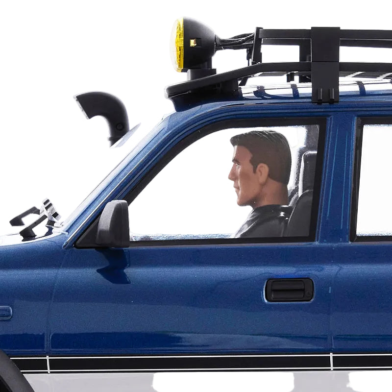Man driving a blue vehicle with a roof rack and light on a white background