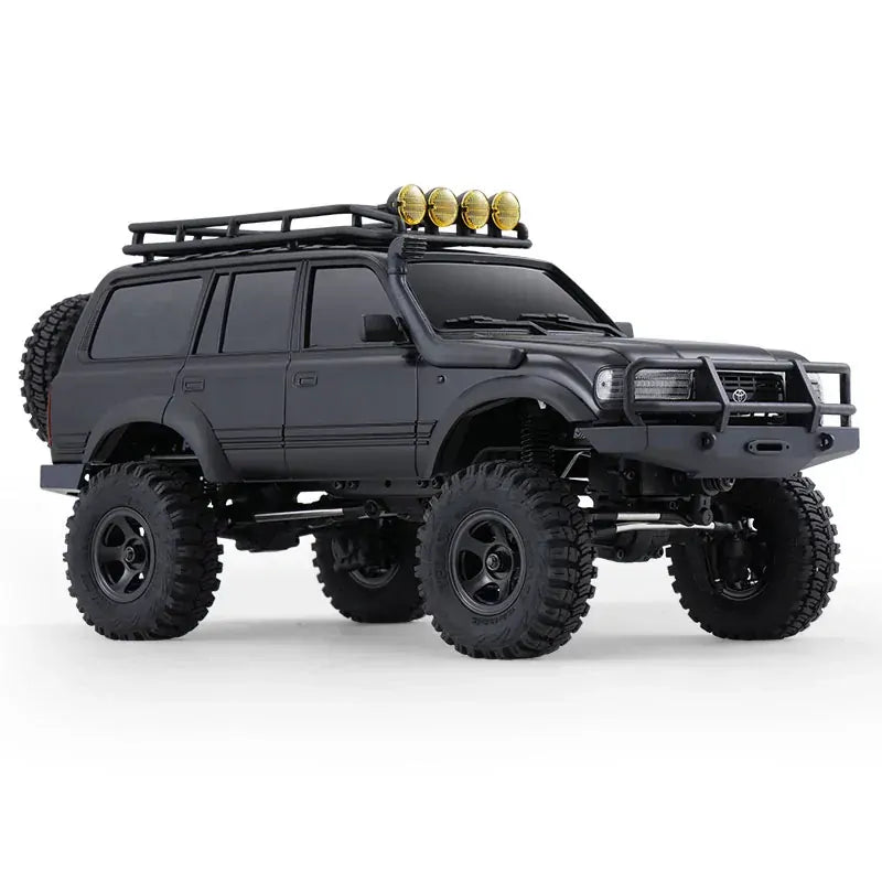 Black off-road vehicle with large tires and roof rack on a white background