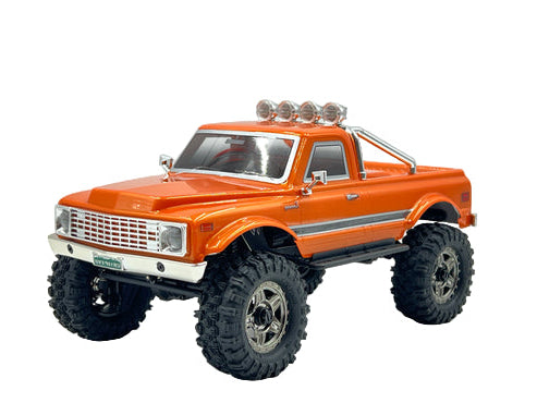 Orange model truck with large wheels on a white background
