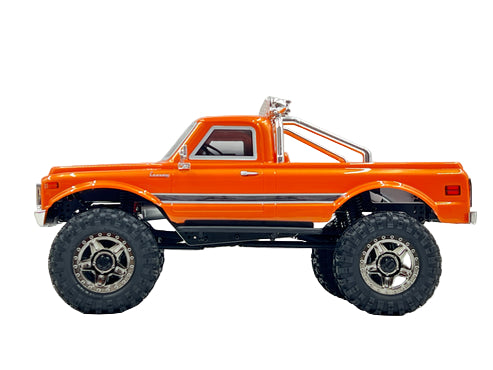 Orange toy truck with large wheels on a gray background