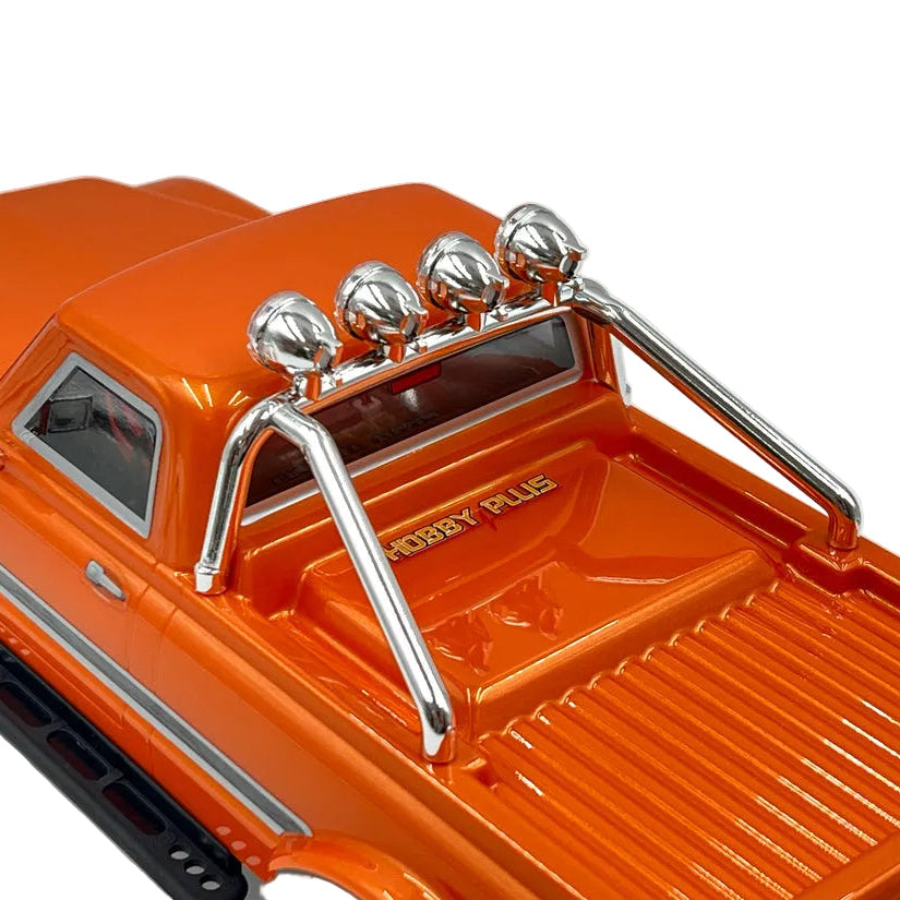 Close-up of an orange toy truck with a metal rack on a white background