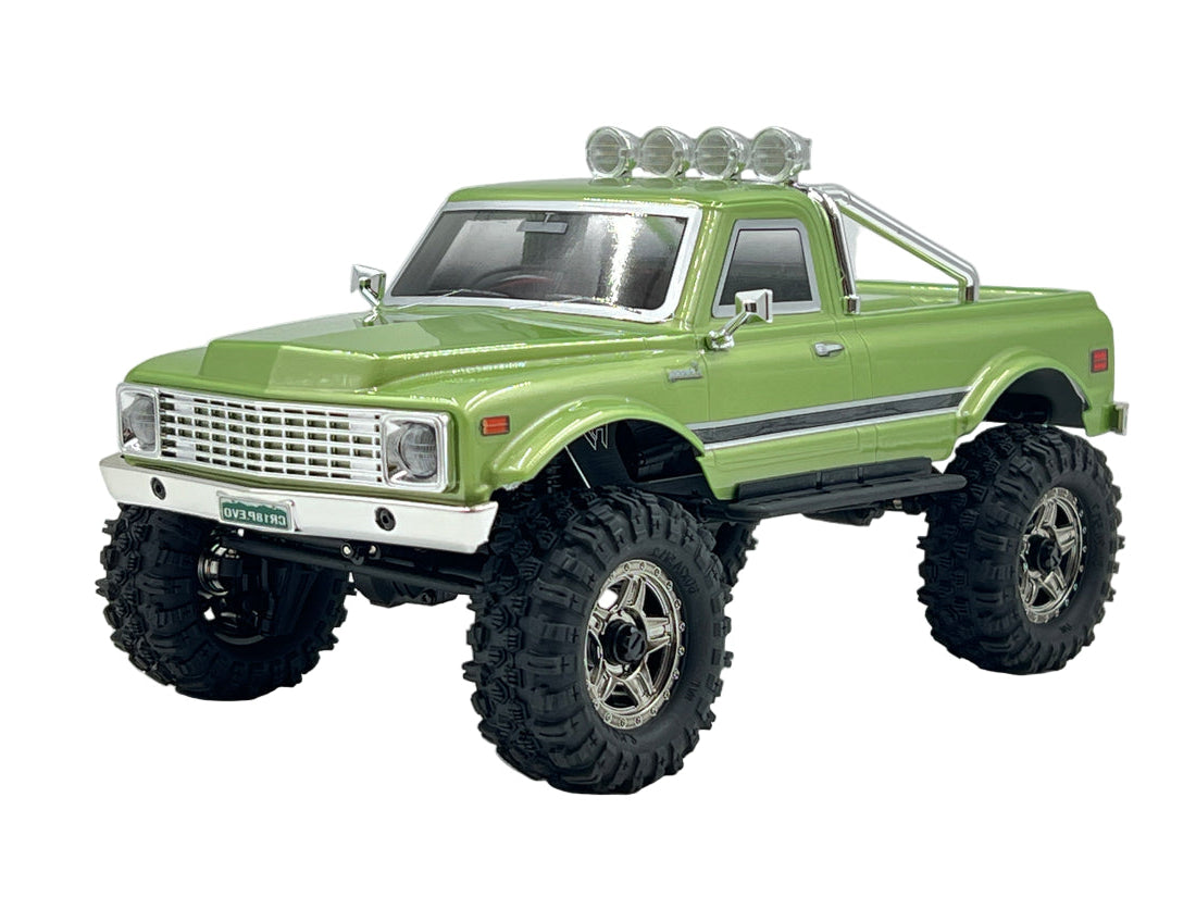 Green model truck with large wheels on a white background