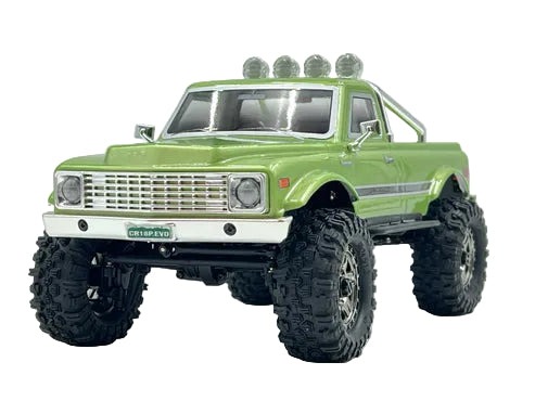 Green model truck with large wheels on a white background