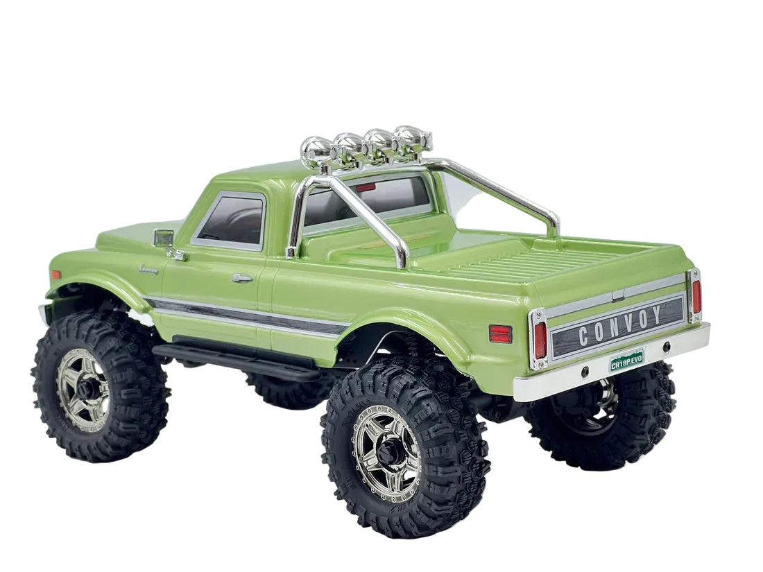 Model truck with large wheels on a white background