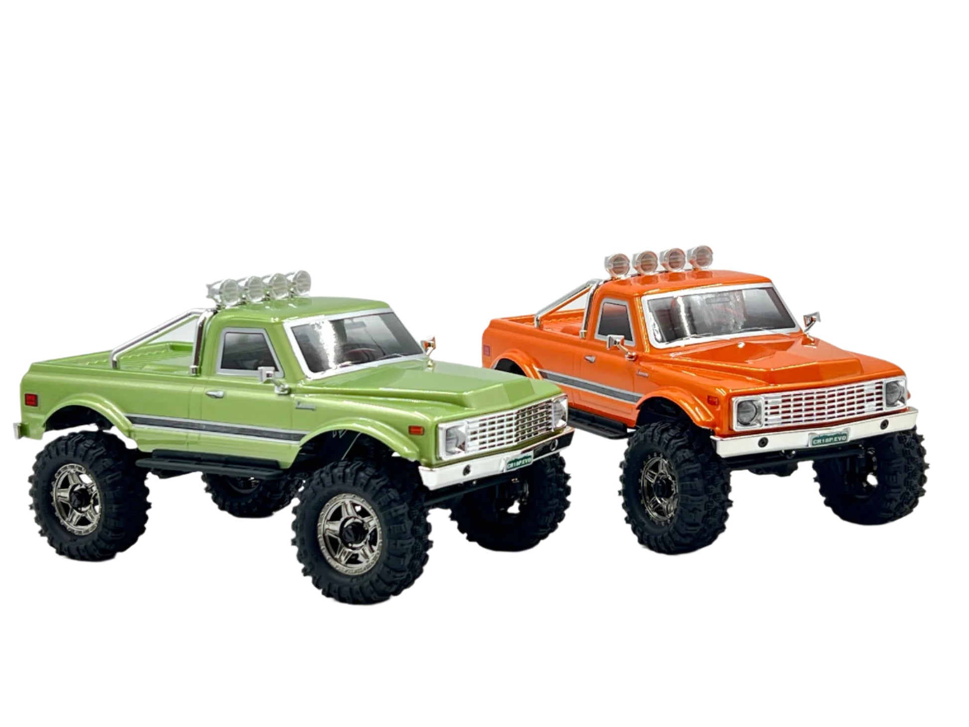 Two Hobby Plus CR18P EVO V2 Convoy RC trucks, one green and one orange, on a white background
