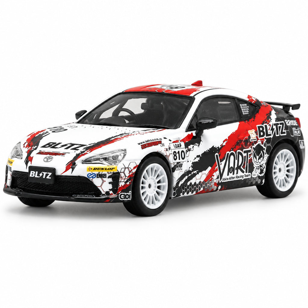 A die-cast model rally car on a plain white background. The car is primarily white with bold red and black graphic decals, featuring sponsor logos such as 'BLITZ', 'VART', and 'Yamaha'.