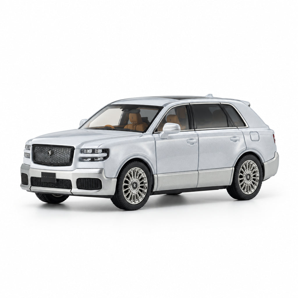 A silver die-cast model of a luxury SUV, resembling a Rolls-Royce Cullinan, displayed on a clean white reflective studio surface.
