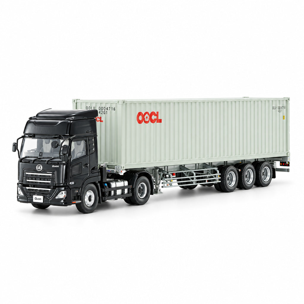 A scale model of a black semi-truck pulling a white OOO shipping container, photographed on a seamless white studio background.