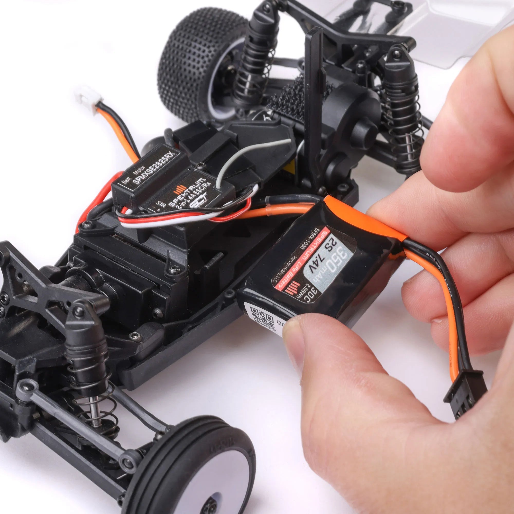 Losi Micro-B 1/24 2WD RC Buggy RTR White - additional angle showing buggy features with the battery in someone's hand.