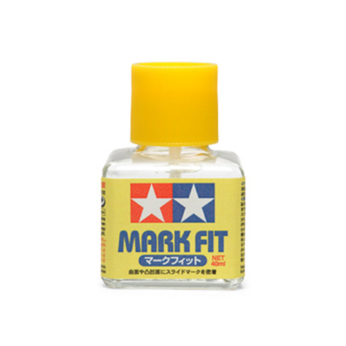 Bottle of Tamiya Mark Fit paint with yellow cap on a white background