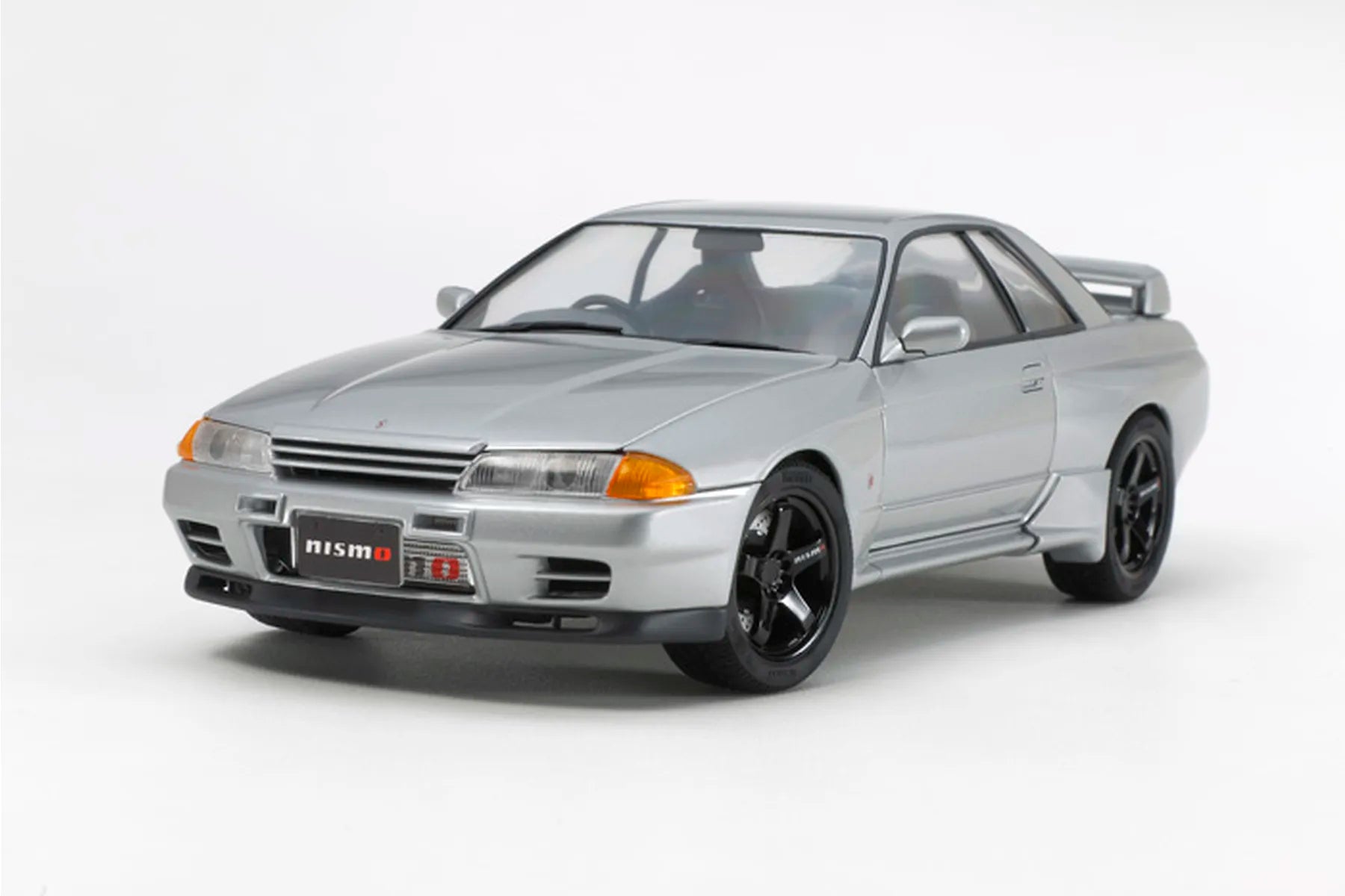 Silver Nissan Skyline GT-R with Nismo badge on a white background
