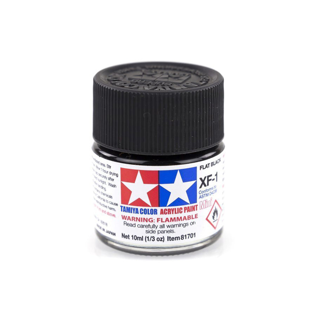 A small glass bottle of Tamiya Acrylic Mini XF-1 Flat Black paint with a black cap and label.