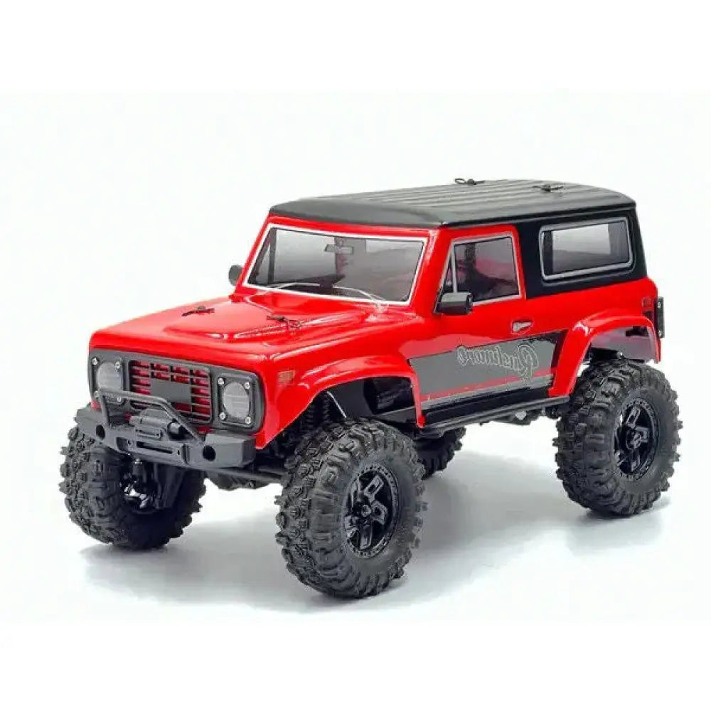 Red off-road model vehicle with black roof on a white background