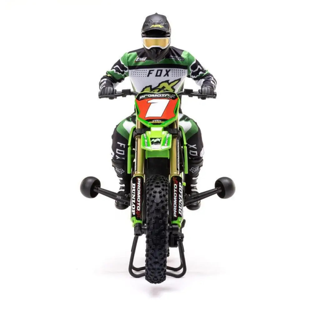 Front view Model of a motocross rider on a green Losi Promoto-MX 1/4 Dirt Bike with visible branding on a white background