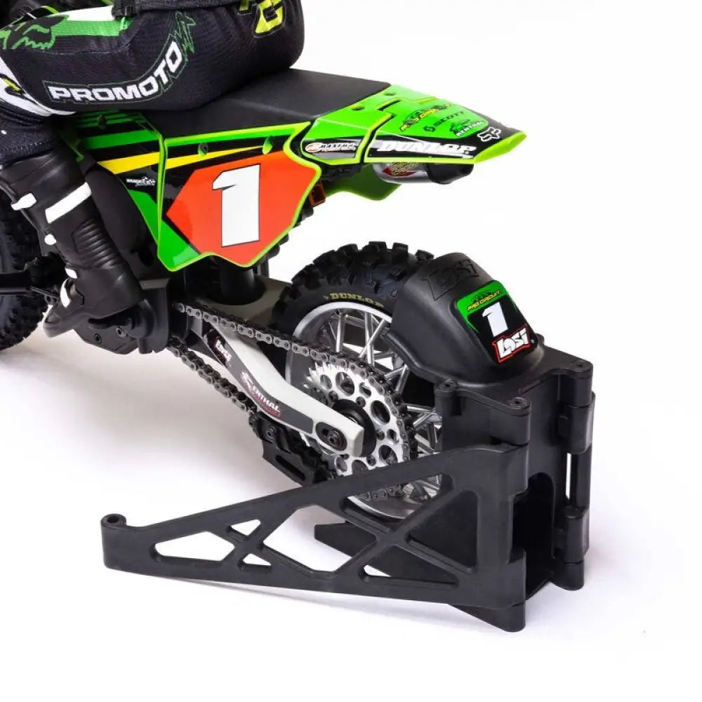 Close-up of a green and black dirt bike with visible branding on a white background