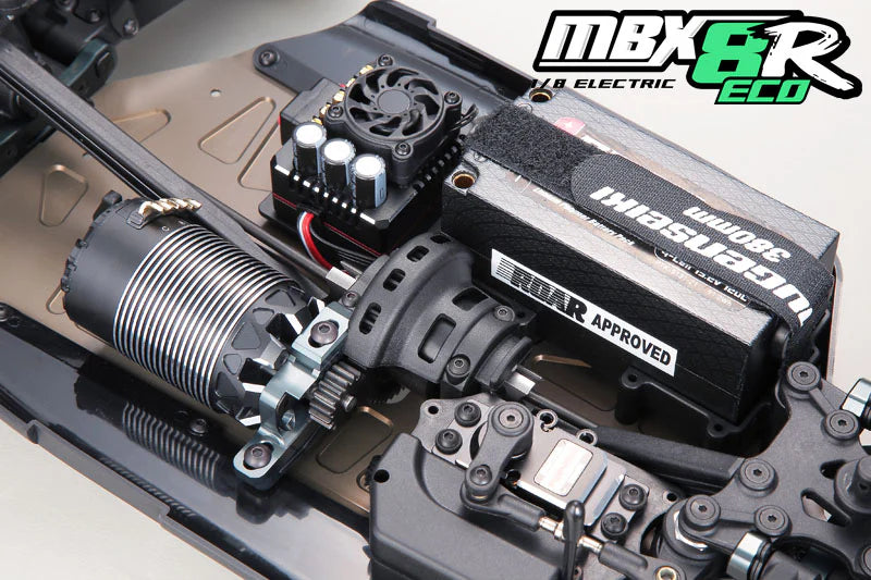 Close-up of RC car components with 'MBX8R' branding on a white background