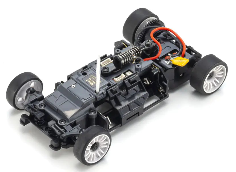 Black chassis of a model car with visible components on a white background