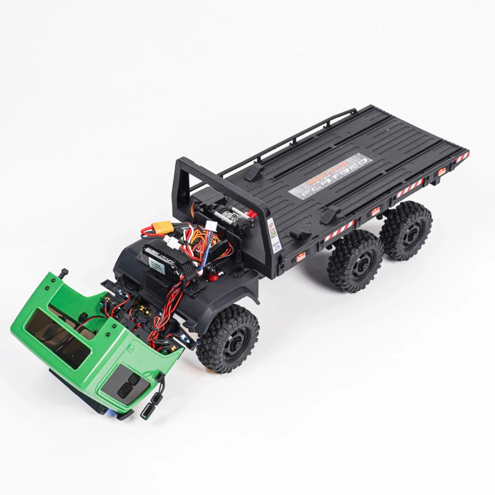 Model of a remote-controlled truck with a flatbed trailer on a white background