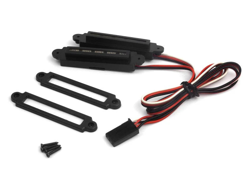 Electronic components including black connectors and red-wired cable on a white background