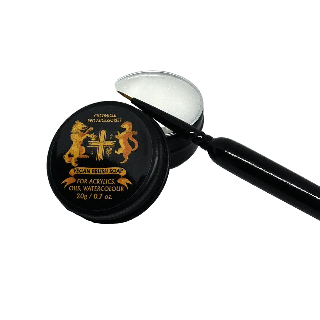 Vegan brush soap with a black handle on a white background