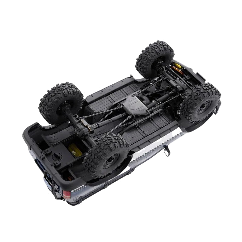 Top view of a black off-road vehicle chassis with large wheels on a white background