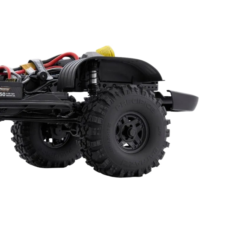 Close-up of a black off-road vehicle chassis with large tires on a white background