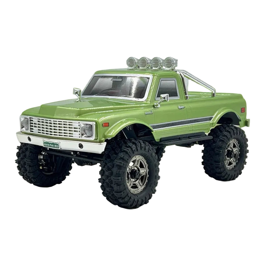 Green model truck with large wheels on a white background