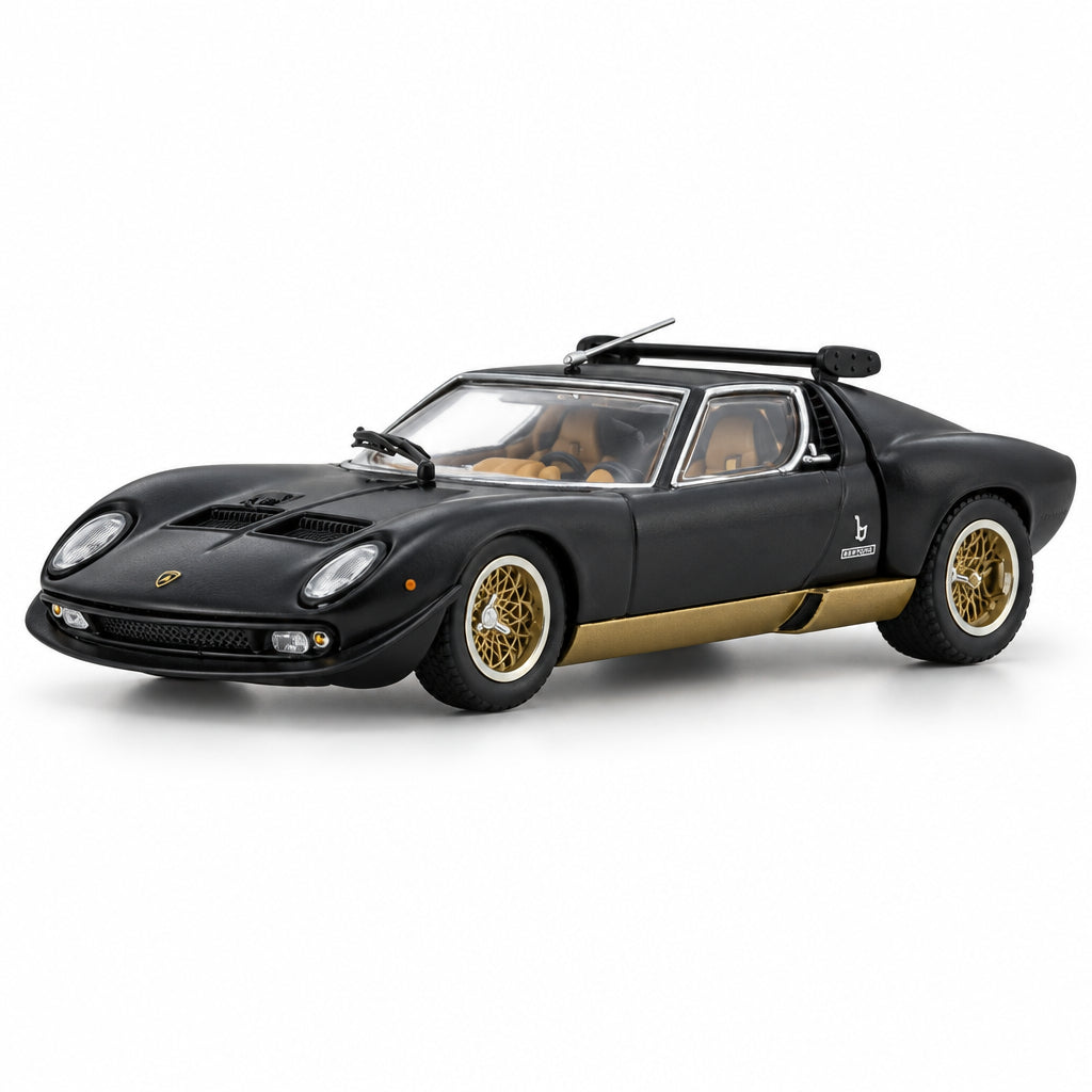A black Lamborghini Miura model car with gold-colored wheels and a gold side stripe, shown on a reflective white surface against a white background.