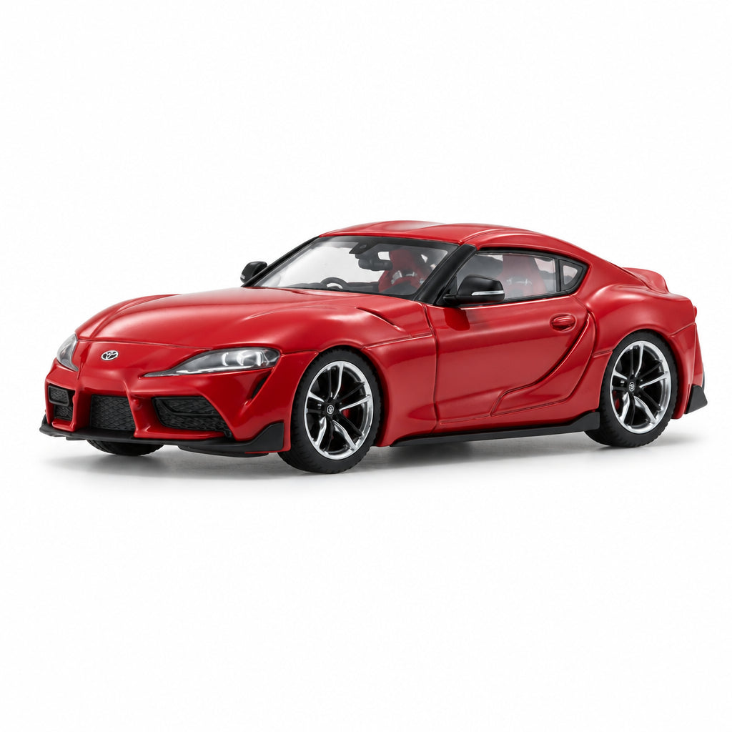 A red die-cast model car of a Toyota Supra, shown from a three-quarters front angle on a clean white studio background with a soft reflection.