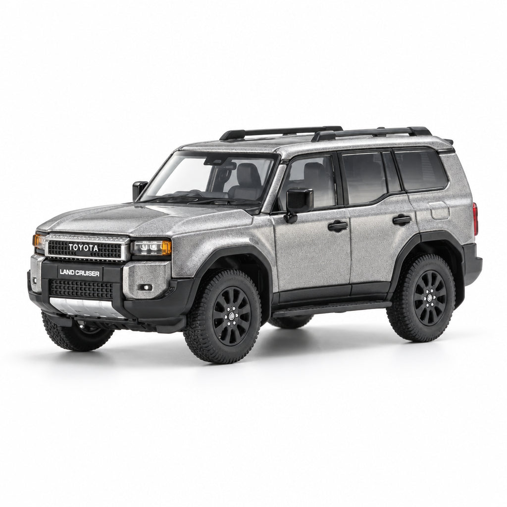 A metallic gray Toyota Land Cruiser SUV model or toy car, shown from a three-quarter front angle on a clean white background with a subtle reflection.