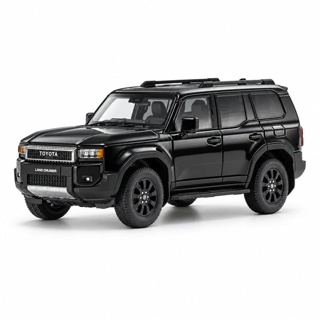 A black diecast model of a Toyota Land Cruiser SUV, shown from a three-quarter front angle on a clean white background with a subtle reflection.