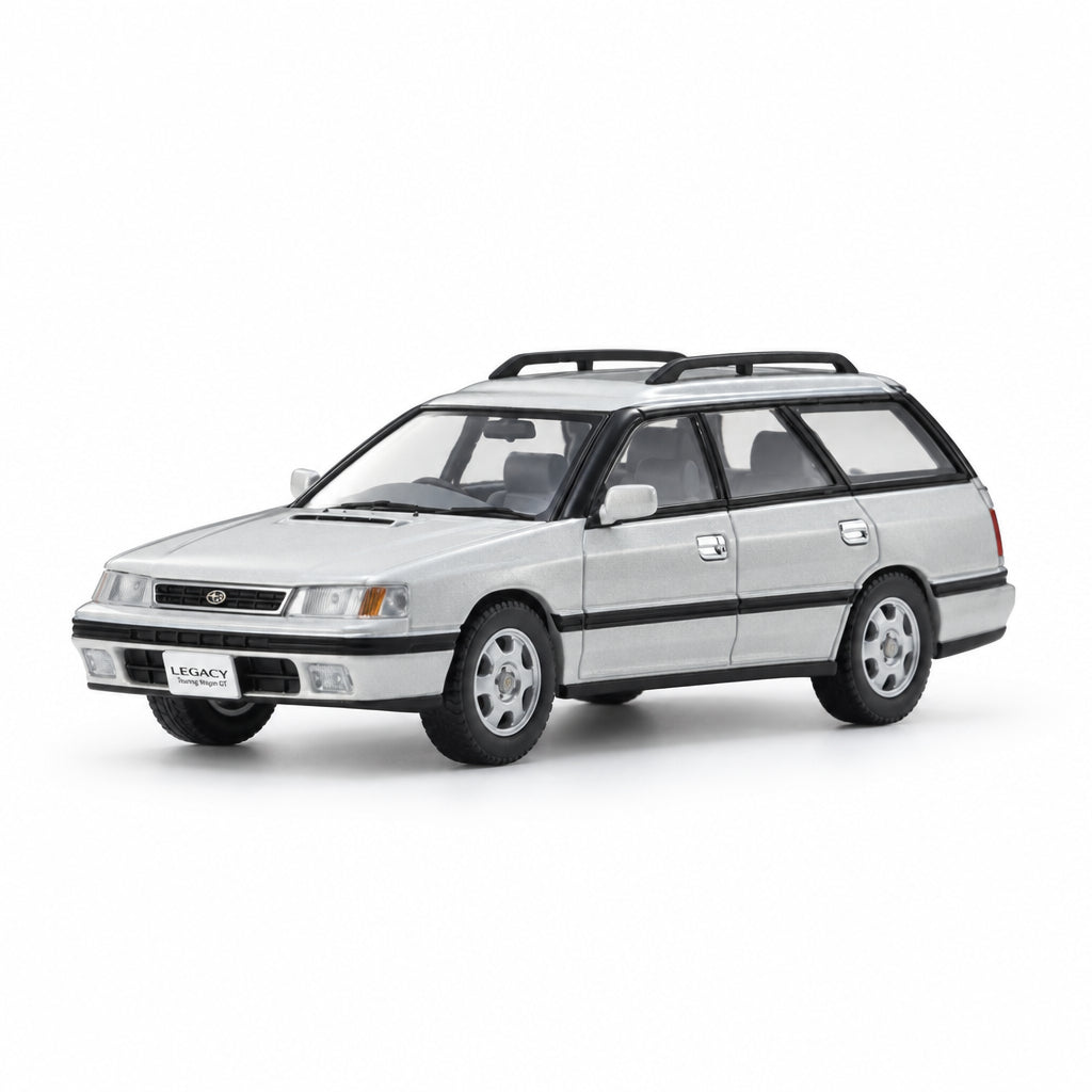 A silver model car with a black roof rack, shown from a three-quarter front angle on a clean white reflective studio background.