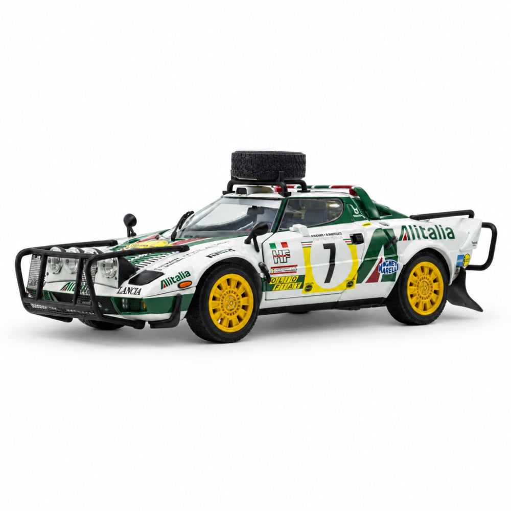A scale model of a white Alfa Romeo rally car with green and yellow livery, featuring a black roll bar, front bumper, and yellow wheels, displayed on a clean white reflective surface.