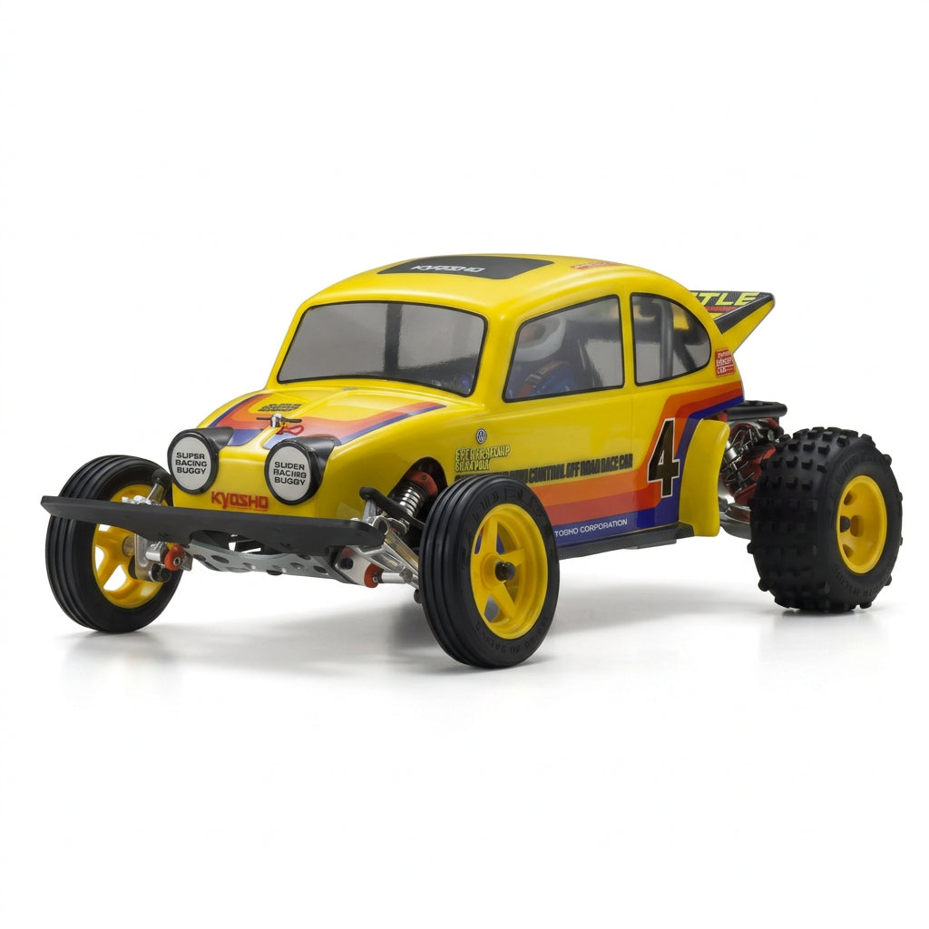 A yellow Kyosho RC car body shell designed for a Volkswagen Beetle, featuring orange and blue graphics, black tires, and racing decals on a gray studio background.