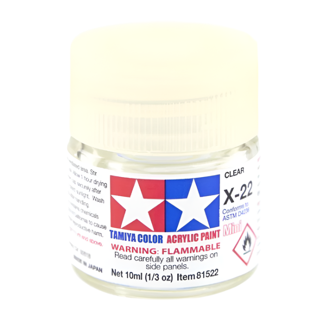 A bottle of Tamiya Acrylic Mini X-22 (87064) Clear paint with a white cap and label.