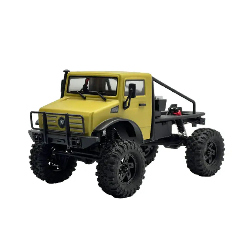Model of a yellow off-road vehicle with large black tires on a white background