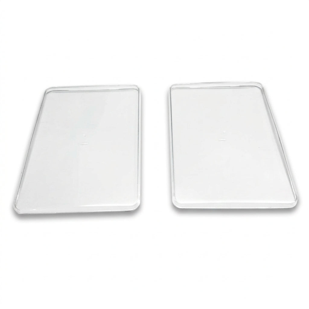 Two clear, transparent rectangular protective cases with rounded corners, displayed side-by-side on a plain white surface.