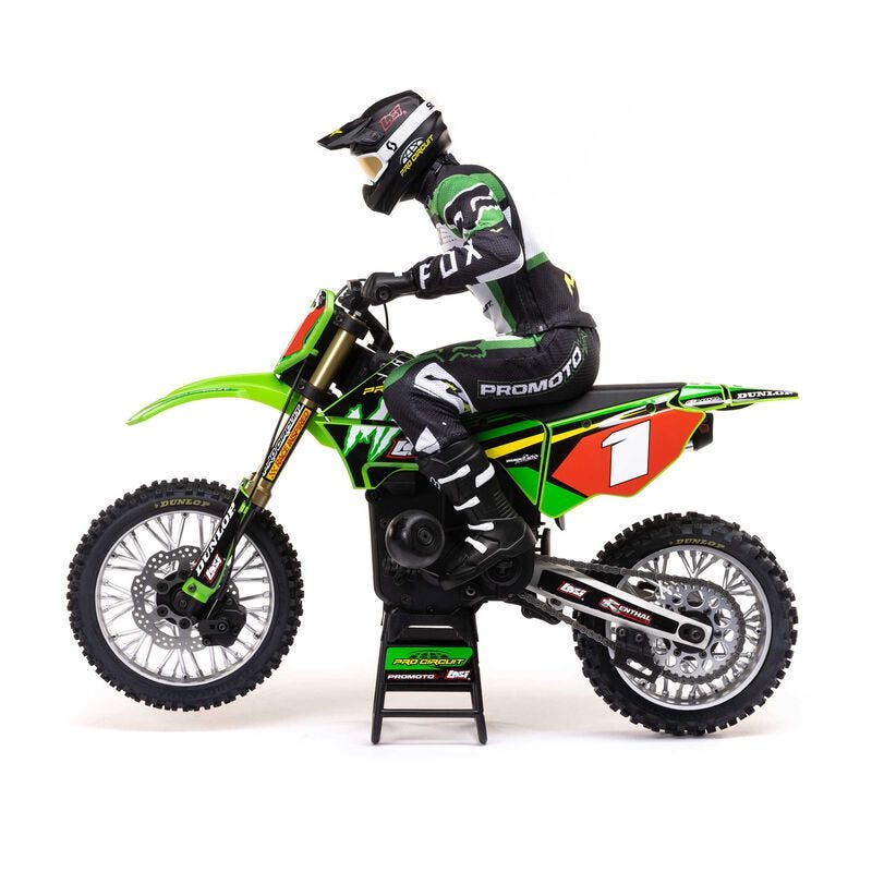 Model of a motocross rider on a green  Losi Promoto-MX 1/4 Dirt Bike with promotional branding on a white background