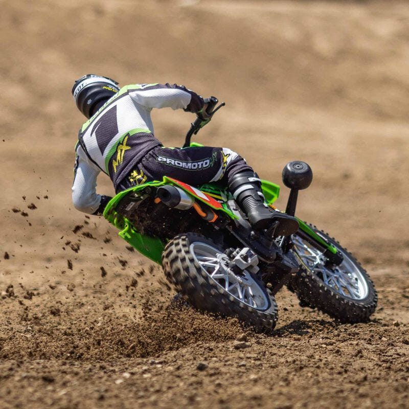  Losi Promoto-MX 1/4 Dirt Bike on a dirt track ejecting dirt roost from rear wheel