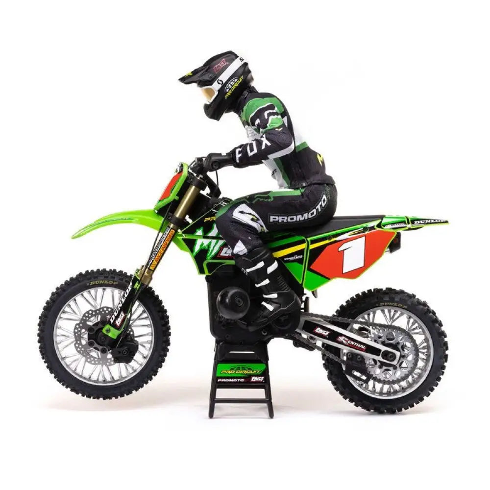 Front view Model of a motocross rider on a green  Losi Promoto-MX 1/4 Dirt Bike with visible branding on a white background