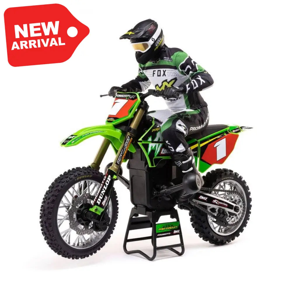 Model of a person on a green Losi Promoto-MX 1/4 Dirt Bike with sponsor logos on a white background
